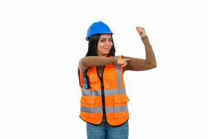 Strong female construction worker flexing biceps and pointing with finger photo
