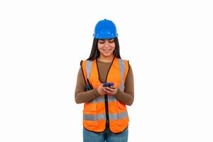 Smiling female engineer using smartphone on white background photo