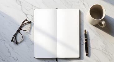 Top Down View of an Open Notebook, Tortoise Shell Glasses, a Black Fountain Pen, and a Coffee Mug on a White Marble Surface with Soft Sunlight and Shadows, Ideal for Mockups and Branding photo