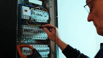 Electricians hands testing current electric in control panel. Electrician engineer work tester measuring voltage and current of power electric line in electical cabinet control. 7 video