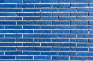 Close up of blue brick wall with unique visual effect, neatly laid bricks create texture and modern aesthetics photo