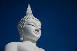 White Buddha Sculpture Face with Blue Sky photo