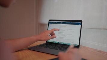 Close-up shot of a person's hand intently interacting with a laptop screen, showcasing focused concentration and digital engagement.Displays a web page with a text interface using a modern chat tool. video