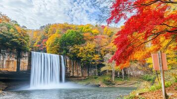 Autumn Waterfall Cascading Through Colorful Foliage photo