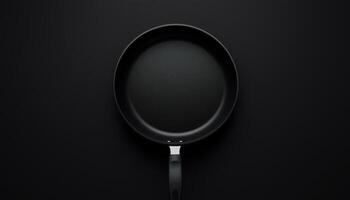 Empty mockup black frying pan flat lay view with dark background photo