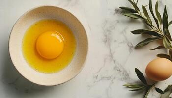 Egg yolk un cook for prepare cooking on bowl in ceramic table with green leaves decoration photo