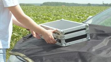 Laboratory worker holding professional glassware and testing plant sprouts before harvest in the field. video