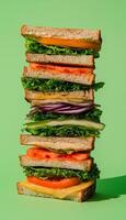 Sandwich layered stack with vegetable, loaf bread and beef meat on green background photo