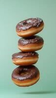 Chocolate cream topping donuts stack sweet snack in blue solid vertical background photo