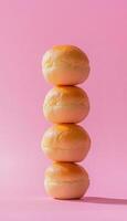 Fried bread stack arranged up in pink vertical background photo