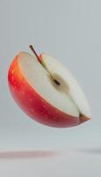 Red apple fruit floating on air with white vertical background photo
