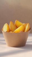 Potato wedges slice on paper bowl recycle container delivery pack photo