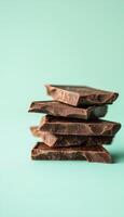 Chocolate brown slices stack sweet snack on soft blue solid vertical bacground photo