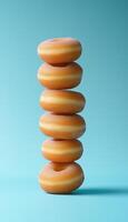 Fried original donuts stack on blue solid vertical background photo