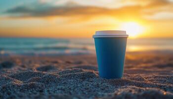 Coffee blank paper cup mockup blue matte color on beach with sunset sky and shell decoration photo