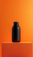 Black bottle tumbler for drink reusable zero waste on orange podium stage photo