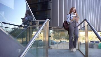 A Young Woman Taking a Selfie Outdoors Against a Backdrop of Modern Architecture Designs video
