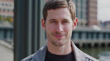 A man is smiling in front of a river video
