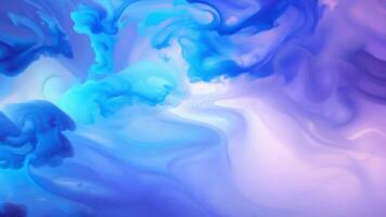Blue ink forming abstract shapes while dissolving in water creating a colorful background video