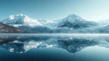 Serene Snow-Capped Mountains Reflecting on a Calm Lake photo