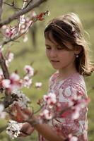 dreamy portrait of a girl in pink surrounded by vibrant pink blossoms, creating a fairytale-like scene photo
