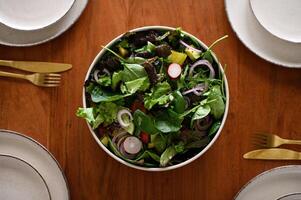 A wholesome salad, rich in colors and textures, is presented on a perfectly arranged table, inviting a delicious experience. photo