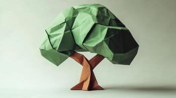 Green origami tree standing on white background photo