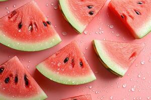 Fresh watermelon slices arranged on pink background creating seamless summer pattern photo