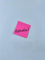 Sticky note with Potential written on it, affixed to white background. Image represents capability and opportunity, ideal for themes of potential and future growth photo