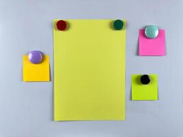 Array of notes attached to whiteboard with magnets suitable for managing tasks and reminders enhancing productivity and organization in office or classroom settings photo