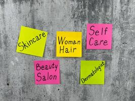 Multicolored stickers with conceptual idea about woman hair. The importance of selfcare and going to beauty salon to take care of your skin and hair. Reminder about woman selfcare routine photo