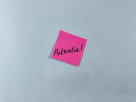 Sticky note with Potential written on it, set on a white background. This image symbolizes growth, opportunity, and capability, suitable for illustrating concepts of potential and future success photo