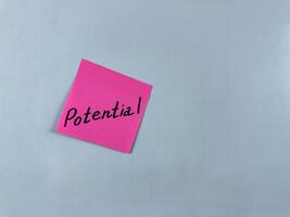 Sticky note with the word Potential written on it, pinned on white background. Photo symbolizes capability, growth, and opportunity. Perfect for illustrating concepts of potential and future success