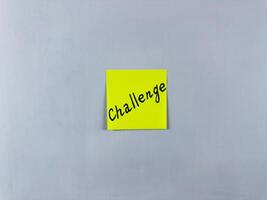 Sticky note with the word Challenge pinned on white background. Photo symbolizes obstacles, goals, and motivation. Perfect for illustrating concepts of taking on challenges and personal growth