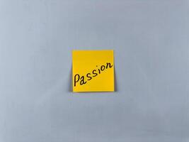 Sticky note with Passion written on it, set on white background. Photo symbolizes strong emotion, enthusiasm, and drive, suitable for illustrating concepts of passion and dedication