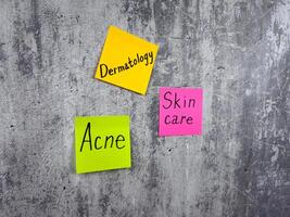 Conceptual photography to remind about the importance of skin care. Epidermis protection and healthy skin. Post it notes with words about the importance of treating skin problems photo