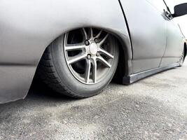 The most lowered car in the world. This car has lowest ground clearance on the planet. Tuned car with stance style suspension for cool look. Custom car with the bottom lowered to the asphalt photo