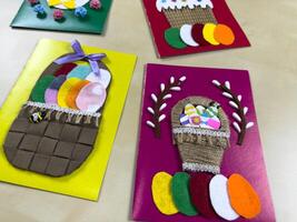 Charming collection of handmade Easter cards features colorful baskets filled with felt eggs and a festive cake. Ideal for sharing joy and warm wishes during Easter festivities photo