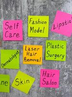 Vertical photo with beauty words on colored sticky notes describing fashion model routine of taking care of her body. Skin care and appearance. Concept of beauty industry with many difficulties