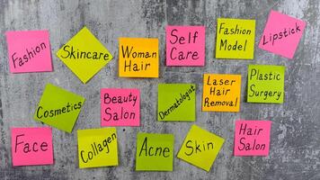 Complicated list of routine tasks for person in fashion industry. Beauty requires sacrifice. Concept with bright stickers with notes on importance of skin care and cosmetic procedures for beauty photo