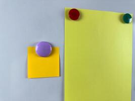 Whiteboard with various notes attached by magnets perfect for organizing tasks and reminders. Increasing productivity and efficiency in office. Classroom education with notes photo