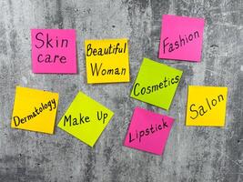 Cosmetic concept for fashion industry with simple design with stickers and words about makeup components. Attractiveness of girl and creating image with help of cosmetics and emphasizing her face photo