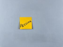 Sticky note with Passion written on it, affixed to white background. This image represents enthusiasm and drive, ideal for themes of passion and dedication photo