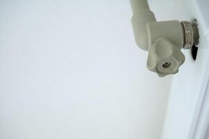 close-up of a plastic valve that fits into the heating system. pipe and radiator with a heating system photo