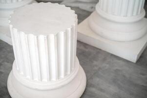 podium of antique plaster columns in the interior. in the foreground is a large column. on the gray granite floor there are three columns. horizontal photo