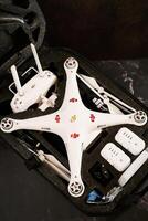 USA, Arizona - March 10, 2025. Complete set of DJI Phantom Professional drone with spare parts lies in a protective case on a black table photo