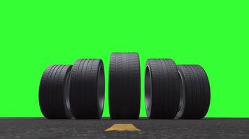 Loop car tires rolling on asphalt in the summer on a green background video