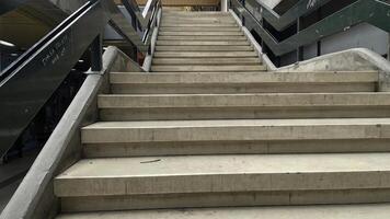 Steps leading to higher levels in an urban shopping area during a bright sunny day, inviting exploration and discovery of stores photo