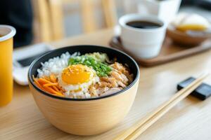 Delicious bowl of rice with chicken, vegetables, and a perfectly cooked egg served in a cozy cafe setting photo