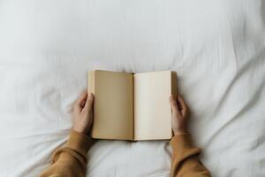 Reading a blank book while relaxing on a soft bed during a quiet afternoon photo